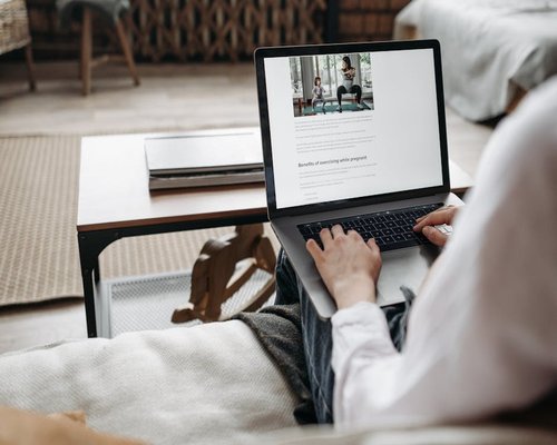 Person working comfortably at a modern desk with a laptop